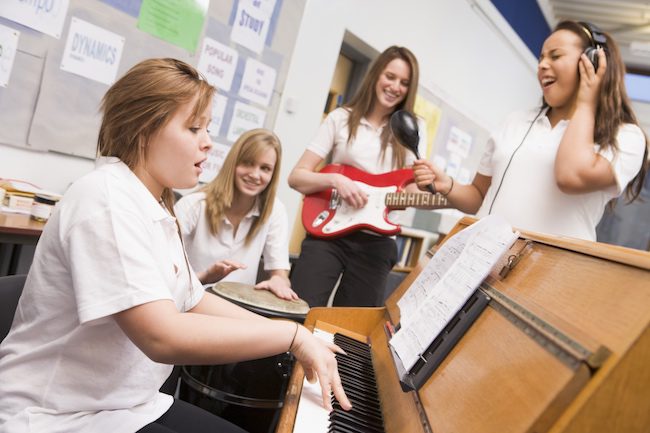 students on different instruments playing together in a band